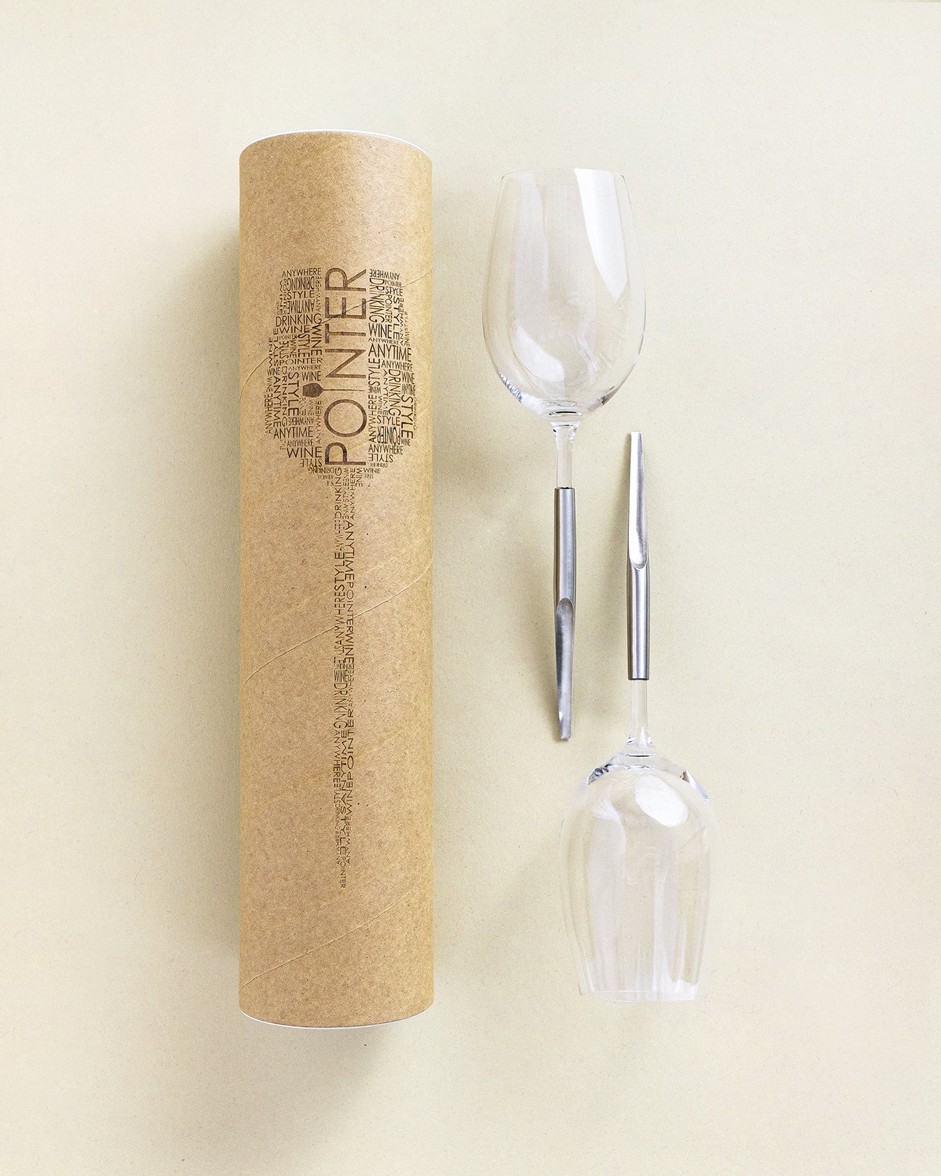 2 picnic wine glasses with metal pins placed horizontally next to each other and next to the packing cylinder box