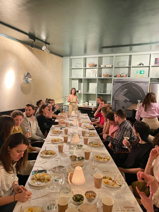 people gathered around an imperial table tasting wines from romania as part of to the pointer wine tasting event hosted by Ramona Enache Lorenz and To The Pointer
