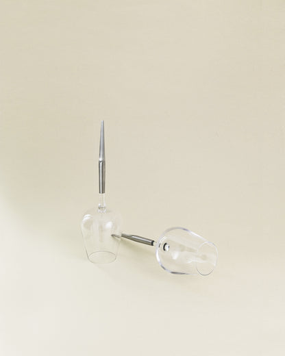 two wine glasses for picnic with metal pin, one upside down and one next to it laying horizontally