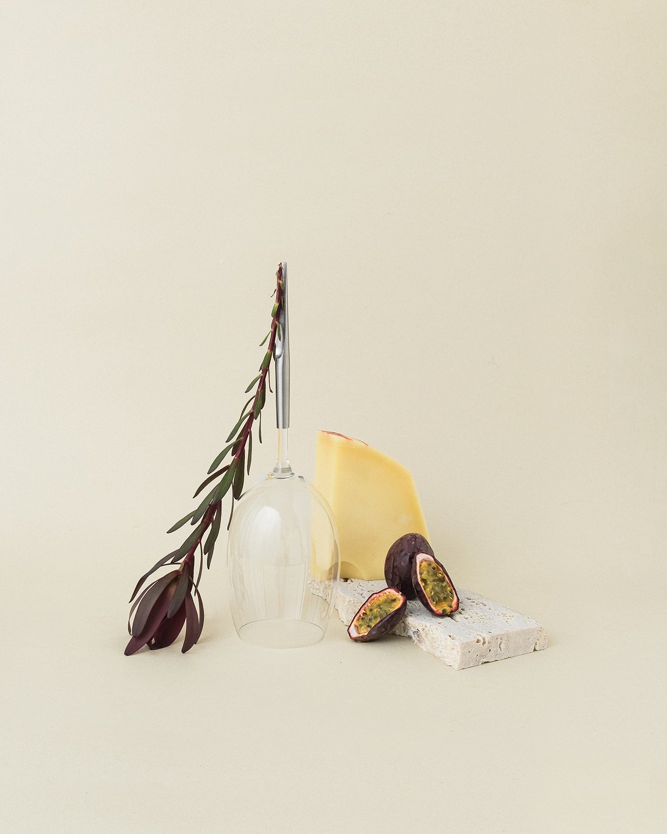 Crystal Red Wine Glasse with metal pin, standing upside-down next to flower and board with figs and cheese