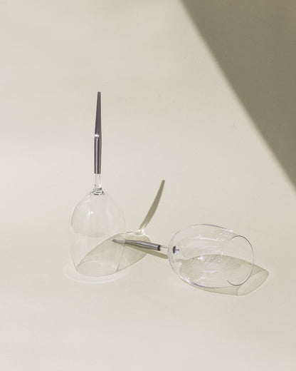Crystal red wine glasses for picnic with metal pin, one laying vertically upside down and one horizontally