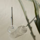 picnic wine glass with metal pin, placed upside down next to plants and shown with shadows