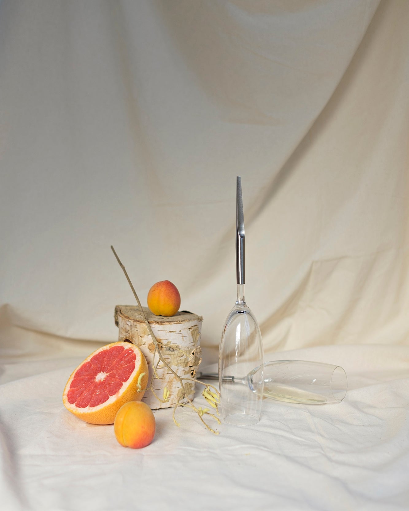 2 Crystal Champagne Glasses with metal Pin, with two peaches and a half-cut grapefruit