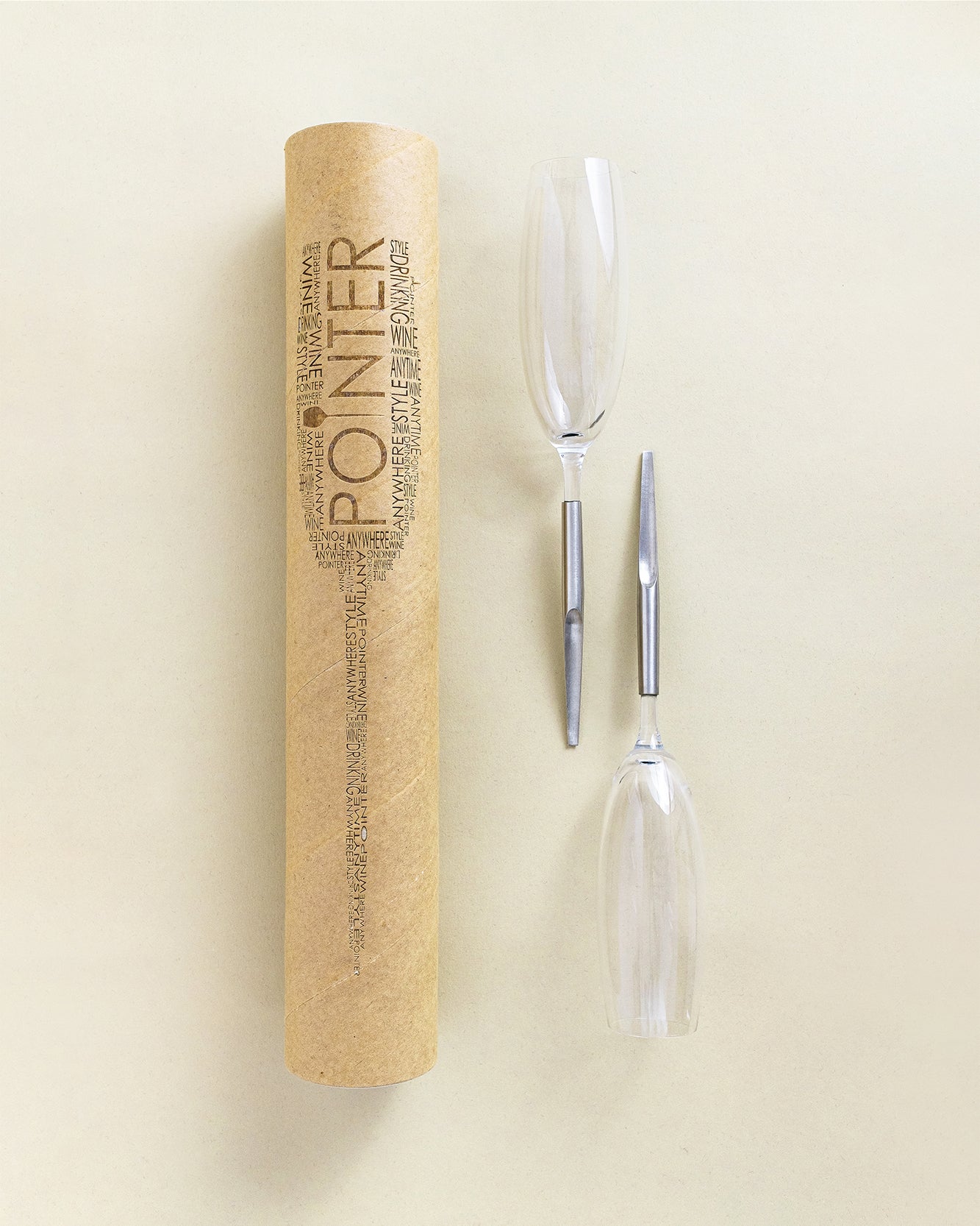 2 Pointer Crystal Champagne Glasses with metal Pin, laying parallel next to cardboard packaging