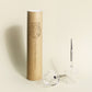 2 picnic wine glasses with metal pin, placed next to their cardboard packing tube for transport, one upside down, one horizontally