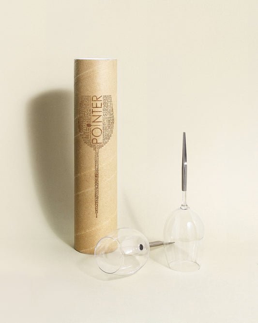 Pointer Wine Glass cardboard tube next to 2 red wine glasses for picnic with metal pin, one laying upside down and the other one place upside down